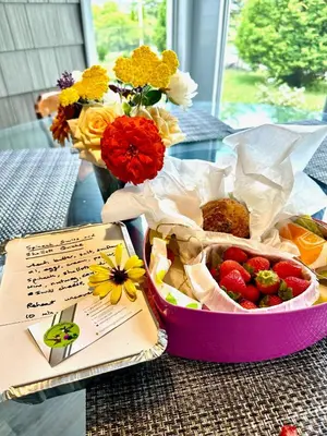 a table with a basket of fruit and flowers at Mountain Ash Country Manor and Spa in Creemore