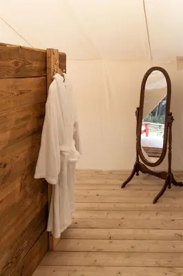 a mirror on a wall next to a dressing room at Homegrown Hideaway in Port Dover