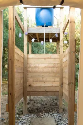 a wooden pergola with a blue bucket in it at Homegrown Hideaway in Port Dover