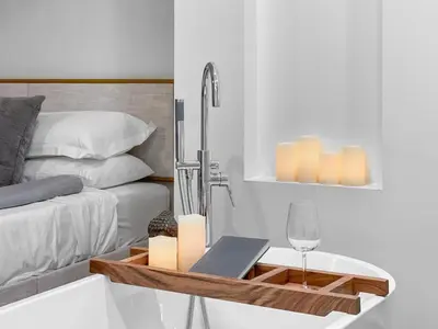 a bedroom with a bed and a table with candles and a wine glass at Elegant 2 Bedroom with Parking in Toronto