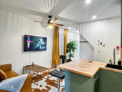 a living room with a ceiling fan and a table at Elegant 2 Bedroom with Parking in Toronto
