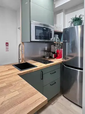 a kitchen with a stainless steel refrigerator and a sink at Elegant 2 Bedroom with Parking in Toronto