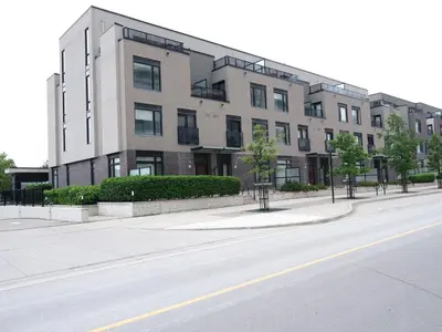 a large building on the side of a street at Executive 3 Bedroom Town House in Mississauga