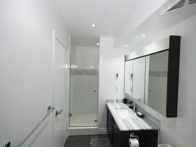 a white bathroom with a sink and a shower at Executive 3 Bedroom Town House in Mississauga