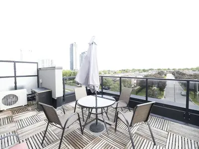 a patio with a table and chairs on a balcony at Executive 3 Bedroom Town House in Mississauga