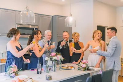 a bride and groom and their wedding party at Elora’s Irvine River Suite in Elora