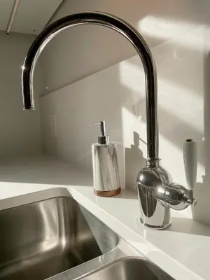 a kitchen sink with a chrome kitchen faucet at Elora’s Irvine River Suite in Elora