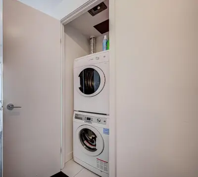 a laundry room with a washer and dryer at Skyline Retreat Residences in Toronto