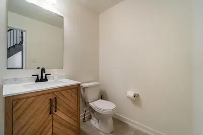 a bathroom with a toilet and a sink and a mirror at Luxury Urban Town home in Oakville