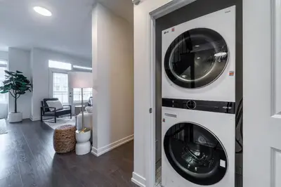 a laundry room with a washer and dryer at Luxury Urban Town home in Oakville