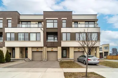 an apartment building with a car parked in front at Luxury Urban Town home in Oakville