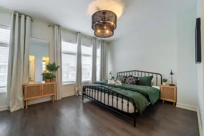a bedroom with a bed and a large window at Luxury Urban Town home in Oakville