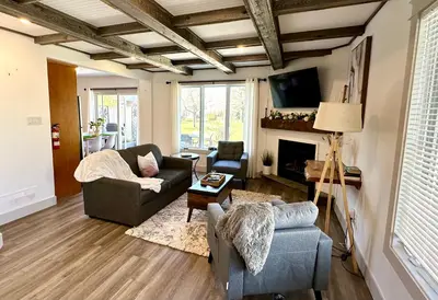 a living room with two couches and a fireplace at Golf Spa Relax in Collingwood