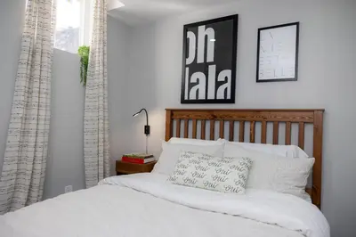 a bedroom with a bed with white sheets and pillows at French Charm in Brampton 2 Bdrm Apt in Brampton