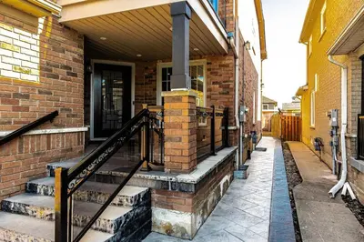 a brick house with stairs and a porch at French Charm in Brampton 2 Bdrm Apt in Brampton
