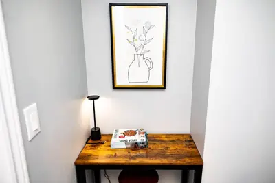 a table with a book and a picture of a vase at French Charm in Brampton 2 Bdrm Apt in Brampton
