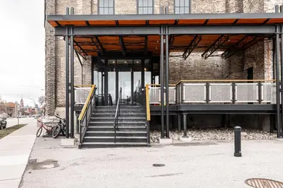 a building with a staircase in front of a building at Glyn Rhosyn Loft in Stratford