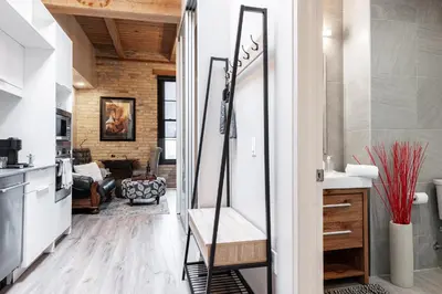 a mirror in a kitchen with a living room at Glyn Rhosyn Loft in Stratford