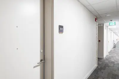 a hallway in a hospital with a sign on a wall at Glyn Rhosyn Loft in Stratford