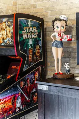a statue of a star wars figurine on a counter next to games at Glyn Rhosyn Loft in Stratford