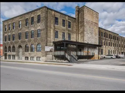 a large brick building on the side of a street at Glyn Rhosyn Loft in Stratford