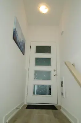 a white door with a window in a room at Niagara Escape Crib: 3km from NiagaraFalls in Niagara Falls