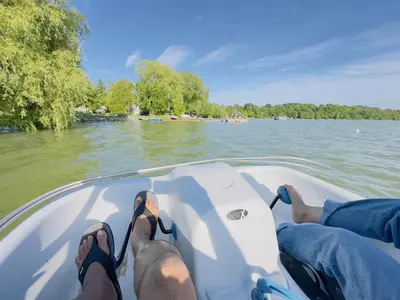 two people on a boat on the water at Charming Winter Cottage Retreat with Scenic Snow Views in Colborne