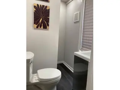a bathroom with a toilet and a sink at Lovely Leslieville, exploring nature in the city in Toronto