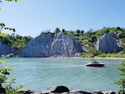a boat on a river with large rocks at Lovely Leslieville, exploring nature in the city in Toronto