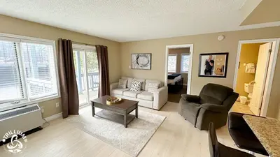 a living room with a couch and a chair at Blue Mtn 1 Bedroom with Mountain View in Blue Mountains