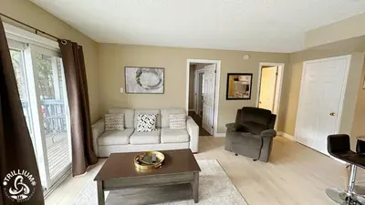 a living room with a couch and a chair at Blue Mtn 1 Bedroom with Mountain View in Blue Mountains