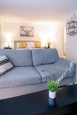 a living room with a blue couch and a bed at Gorgeous Studio Condo in Blue Mountains Sleeps 4 in Blue Mountains
