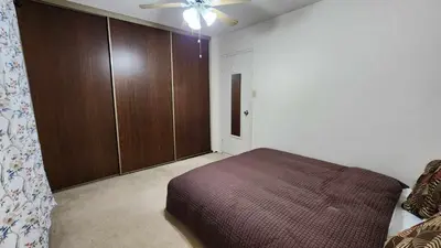 a bedroom with a bed and a ceiling fan at Cozy Town house in Toronto