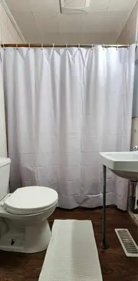 a bathroom with a toilet and a sink at Cozy Town house in Toronto