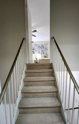 a staircase in a home with white walls and a stair case at Cozy Town house in Toronto