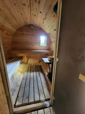 an inside view of a wooden cabin with a window at Red Cedar Chalet on Brady Lake in Hindon Hill