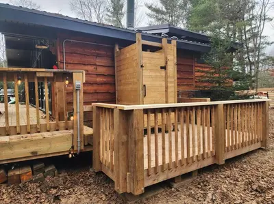 two wooden fences in front of a building at Red Cedar Chalet on Brady Lake in Hindon Hill