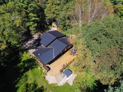 an aerial view of a house in the woods at Red Cedar Chalet on Brady Lake in Hindon Hill