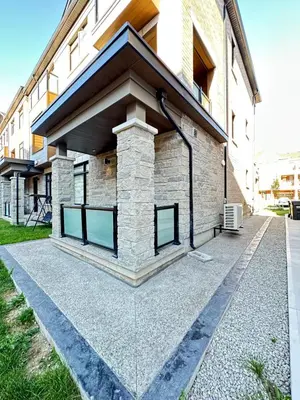 a building with glass doors on the side of it at Keppel Circle Residence in Brampton