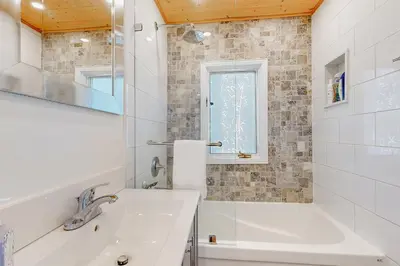 a white bathroom with a tub and a sink at 2889 Purvis Street in Innisfil