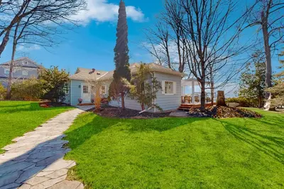 a white house with a grass yard at 2889 Purvis Street in Innisfil