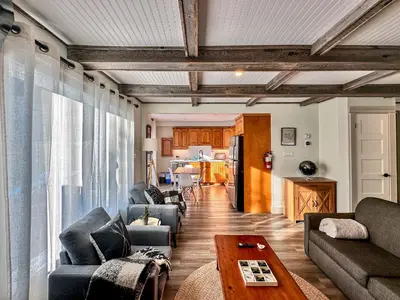 a living room with couches and a table and a kitchen at 40BKickBack in Collingwood