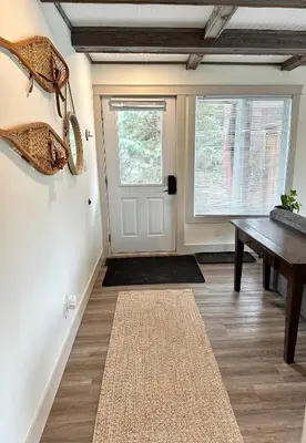 a room with a door and a table and a rug at 40BKickBack in Collingwood