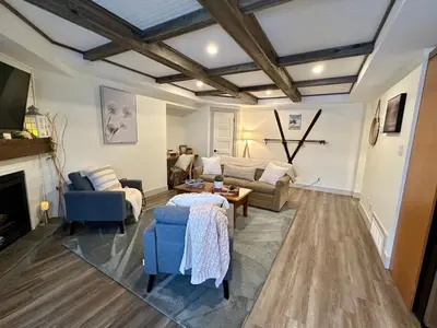 a living room with a couch and a table at Beautiful tranquil centrally located condo in Collingwood