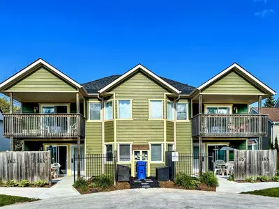 a large house with a fence in front of it at Spa Golf Bike in Collingwood