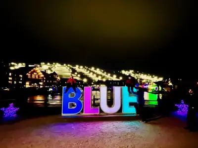 a blue sign with people on it at night at Spa Golf Bike in Collingwood