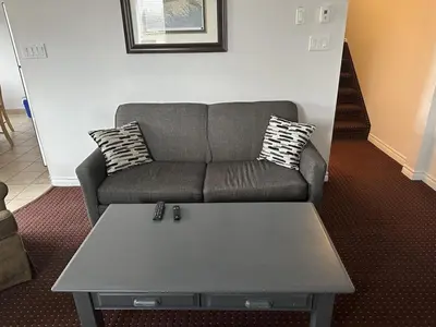 a living room with a couch and a coffee table at Spa Golf Bike in Collingwood