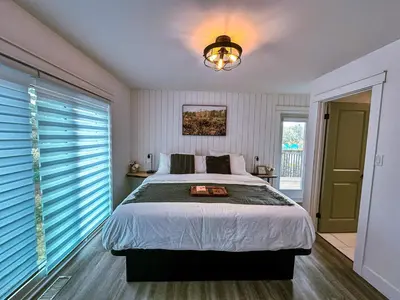 a bedroom with a bed and a large window at Greenview Retreat in Collingwood