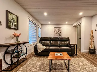 a living room with a leather couch and a table at Greenview Retreat in Collingwood