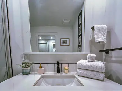 a white bathroom with a sink and a mirror at Greenview Retreat in Collingwood